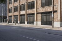 a person in the middle of an empty road with no people on it, walking down a sidewalk