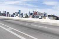 an empty highway with some signs on it in the city area in front of a few buildings