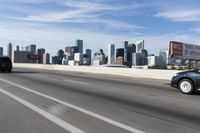 an empty highway with some signs on it in the city area in front of a few buildings