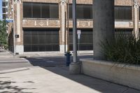 this is an empty street with buildings in the background and a flag pole that says fire department