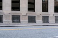 a fire hydrant standing in the middle of an empty street on a city street