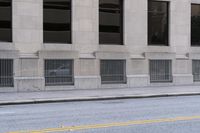 a fire hydrant standing in the middle of an empty street on a city street