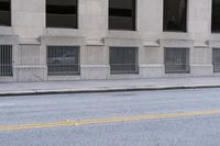 a fire hydrant standing in the middle of an empty street on a city street