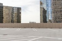 the empty parking lot is full of cars and buildings with reflections on it's windows