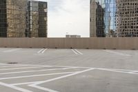 the empty parking lot is full of cars and buildings with reflections on it's windows