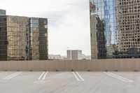 the empty parking lot is full of cars and buildings with reflections on it's windows