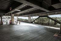 a empty warehouse area with stairs going up to it and concrete floors in front of the stairs