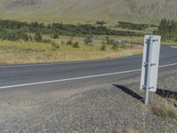 a sign on the side of a country road warning drivers to use an automatic speed control system