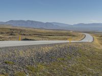 Iceland: Endless Road through Mountain Grassy Plains