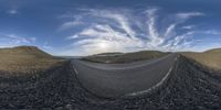 the curved highway is surrounded by mountains on a sunny day at sunrise time for a 360 - zoom