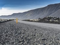 a very narrow winding road running through the middle of nowhere and surrounded by large rocks