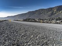 a very narrow winding road running through the middle of nowhere and surrounded by large rocks