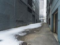 a fire hydrant in the middle of an icy alleyway leading to tall buildings