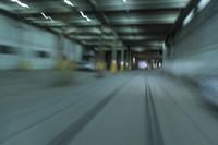 cars driving through an underground tunnel at night time, blurred with lights as the speed of light is approaching