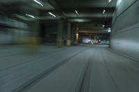 cars driving through an underground tunnel at night time, blurred with lights as the speed of light is approaching