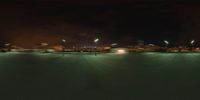 a cityscape view with a few lights on a dark night time scene at an airport