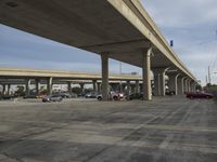 an empty parking lot under a bridge is shown in this photo taken in the us