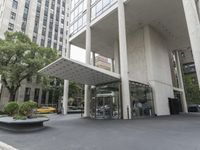 an empty street next to a parking lot with buildings and parked cars on the side of it