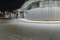 a parking garage filled with lots of glass walls and silver trims on top of it