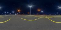 an empty parking lot with light poles on the ground and bright lights on both sides