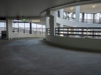a photo of a room inside of an indoor building, with a view out into the air