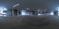 a fish eye view of a large indoor parking lot with a big ceiling over the space