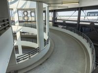 an indoor racing track for vehicles going through a building near buildings that are being used