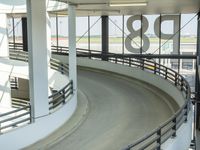 an indoor racing track for vehicles going through a building near buildings that are being used