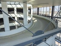 an indoor racing track for vehicles going through a building near buildings that are being used