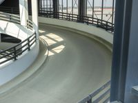 an indoor racing track for vehicles going through a building near buildings that are being used