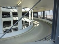 an indoor racing track for vehicles going through a building near buildings that are being used