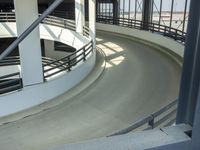 an indoor racing track for vehicles going through a building near buildings that are being used