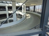 an indoor racing track for vehicles going through a building near buildings that are being used