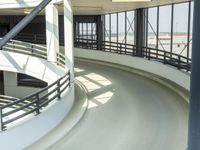 an indoor racing track for vehicles going through a building near buildings that are being used