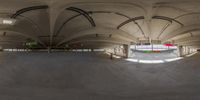 an indoor skate park with an empty floor and several rows of ramps as well as a ramp