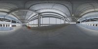 a view of a large indoor structure with multiple roof tops above the building where a skateboarder can perform tricks