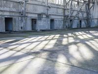 a large abandoned factory or industrial building with windows and a skateboarder riding through a tunnel