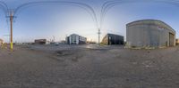 an upside down picture of some buildings and wires in the background from fisheye view