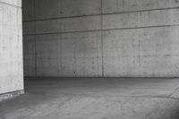 a man riding his skateboard in an old concrete parking garage with high rise walls