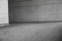 a man riding his skateboard in an old concrete parking garage with high rise walls