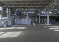 an industrial building with large windows and concrete flooring and light casting area, as well as an air conditioner