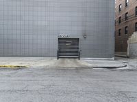 an industrial building with a door in front of it and an open door in the center