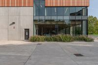 the entrance to an industrial building, with windows and lots of glass walls, is seen at the front entrance