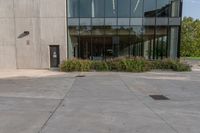 the entrance to an industrial building, with windows and lots of glass walls, is seen at the front entrance