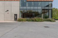 the entrance to an industrial building, with windows and lots of glass walls, is seen at the front entrance