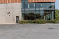 the entrance to an industrial building, with windows and lots of glass walls, is seen at the front entrance