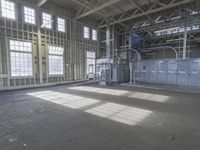 this is a picture of an industrial building with many large windows and electrical equipment inside the building