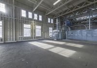 this is a picture of an industrial building with many large windows and electrical equipment inside the building