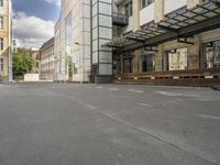 an empty building with signs on the street and people on bikes in traffic passing by