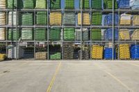 rows of green and yellow boxes stacked on top of each other in an open garage